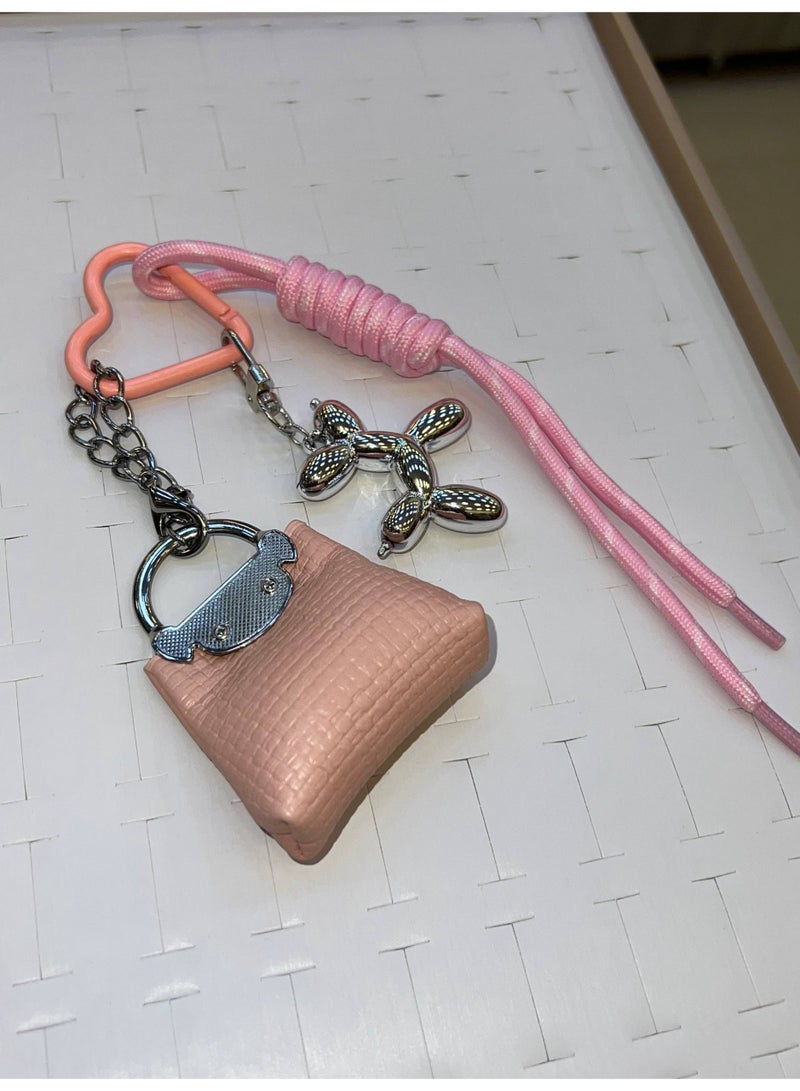 A stylish heart-shaped bag and keychains in assorted colors - Image 1